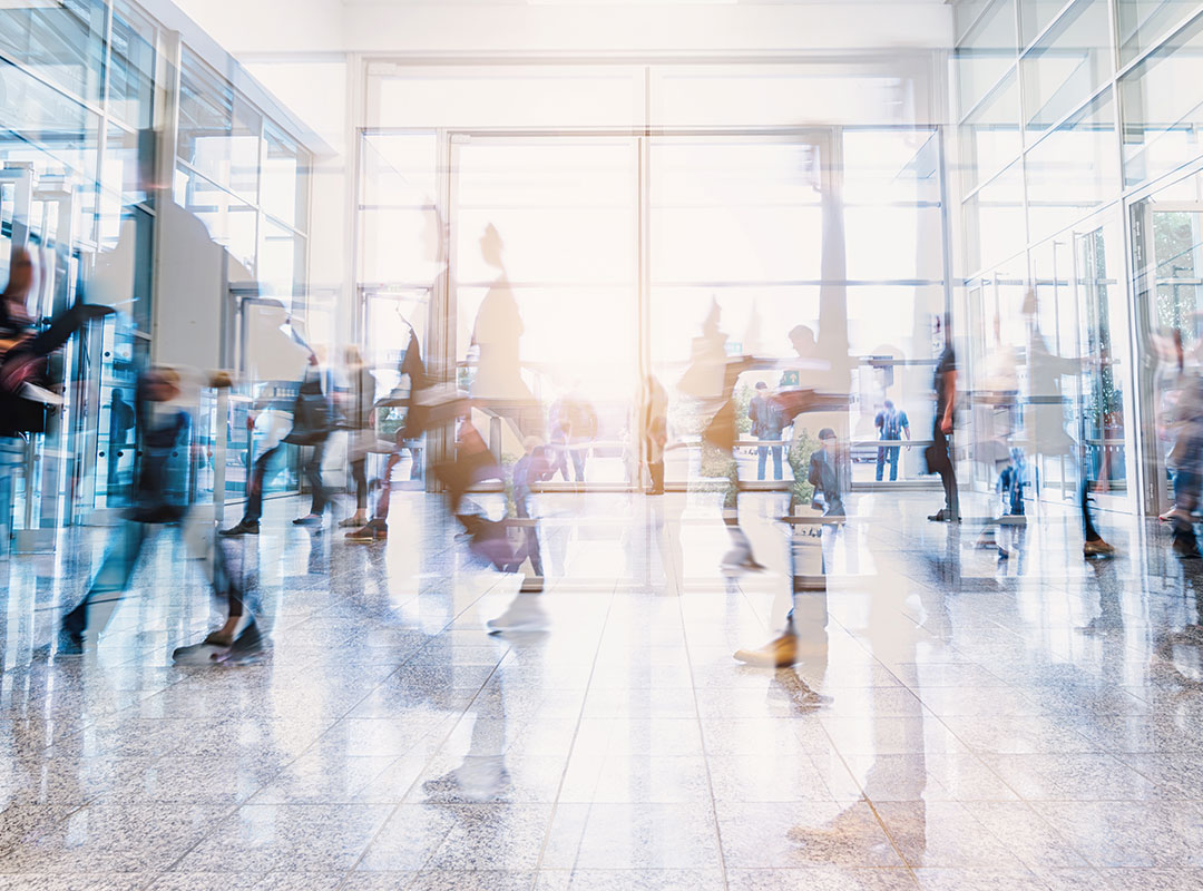 People walking through a foyer of a modern building